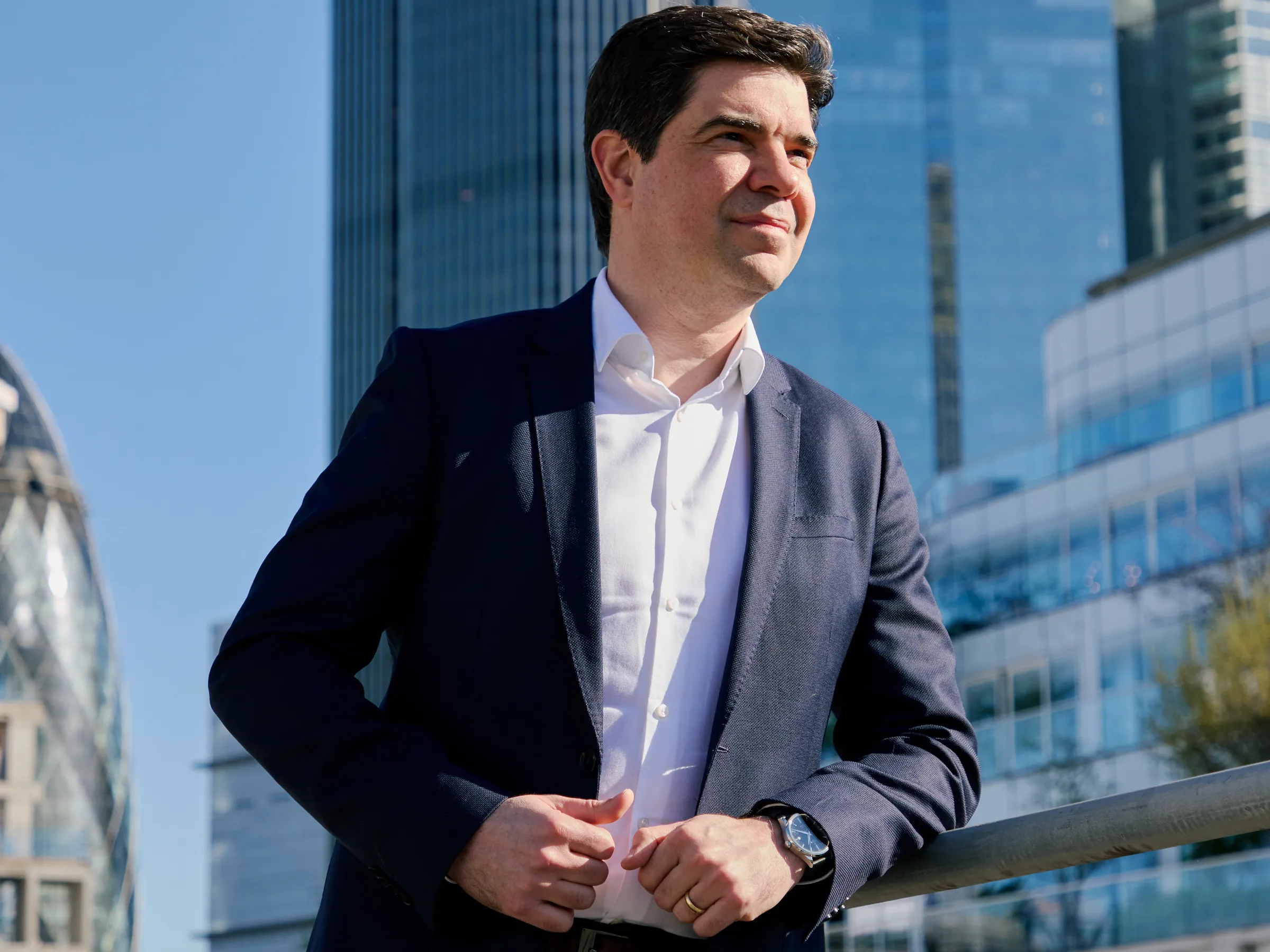 Bruno Genovese on a London rooftop, City of London skyline behind him